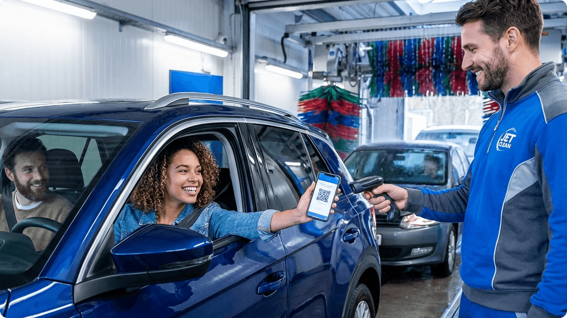 Customer showing a QR code on a smartphone to a car wash attendant for scanning at the wash.